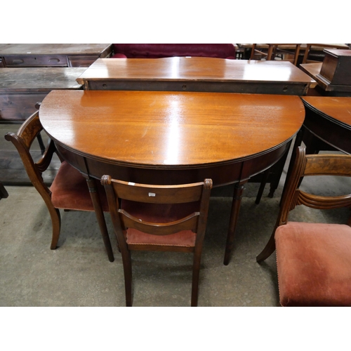 208 - A pair of George IV mahogany demi-lune console tables