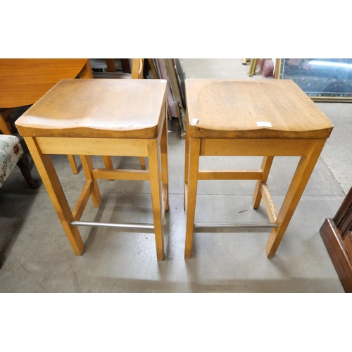 217 - A pair of beech laboratory stools