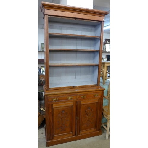 227 - A late Victorian carved walnut bookcase