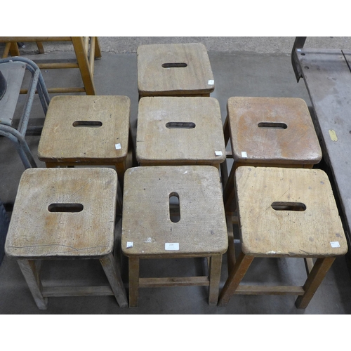 228 - Seven oak laboratory stools