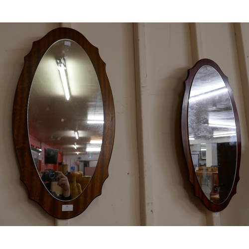23 - A pair of teak framed mirrors