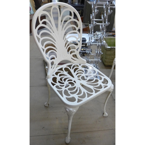 234 - A painted cast alloy garden table and four chairs