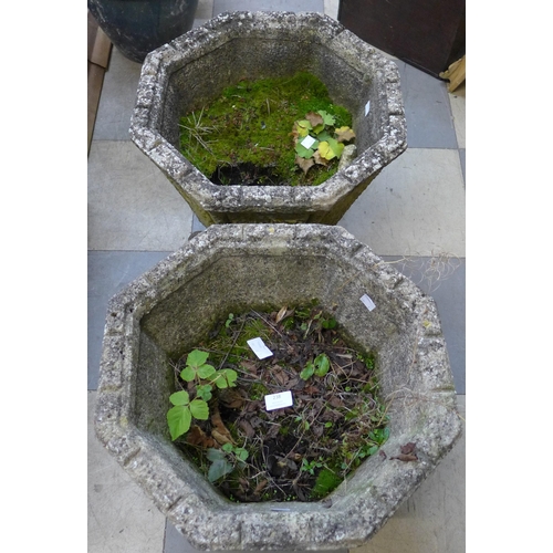 238 - A pair of concrete garden planters, on wrought steel stands