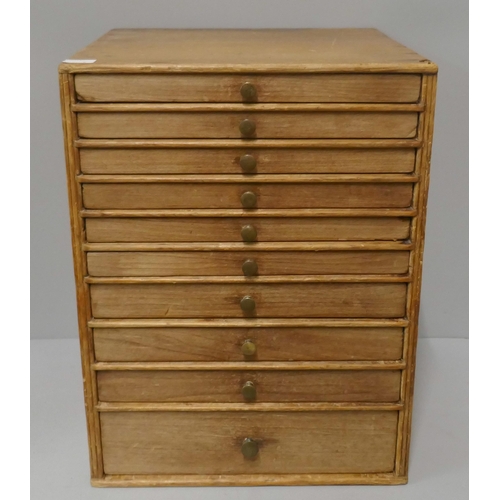 270A - A pine table top ten drawer collector's chest and a letter rack