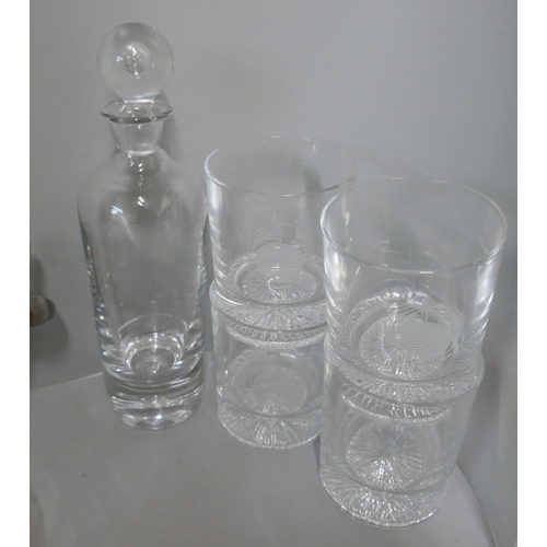 303 - A Swedish Kosta Boda glass Pippi decanter, four whisky tumblers, crystal biscuit barrel and two heav... 