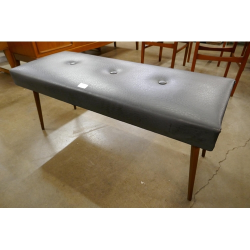 39 - A teak and black vinyl stool