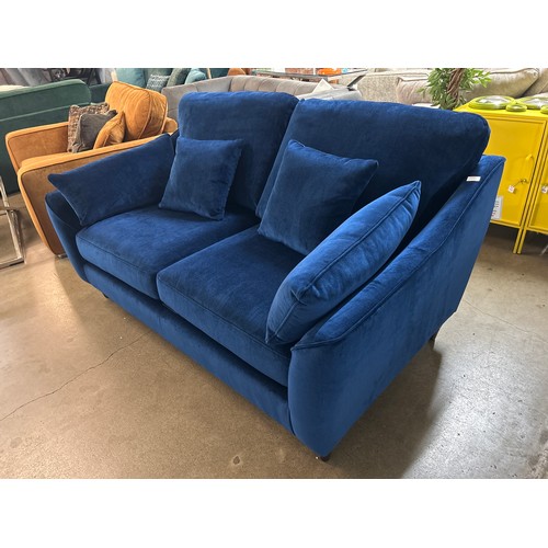 1418 - A blue velvet two seater sofa, RRP £1772