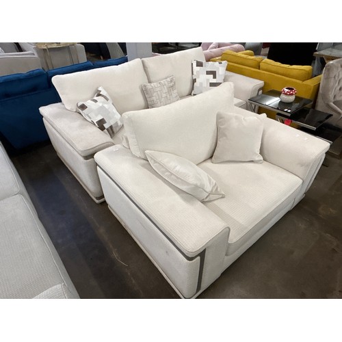 1493 - A cream three seater sofa and love seat with steel trim - handling marks RRP £5598