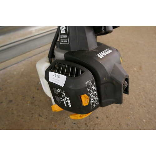 2225 - A petrol driven Titan TT5MTPZ6-2 multi tool with multiple attachments including chainsaw and hedge c... 