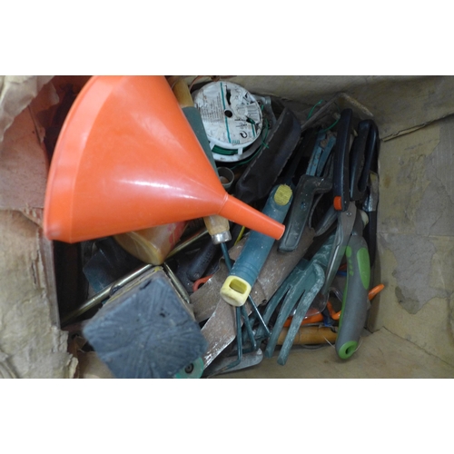 2414 - A large quantity of mixed garden tools including shears, pruning saw, trowels, forks, ear defenders ... 