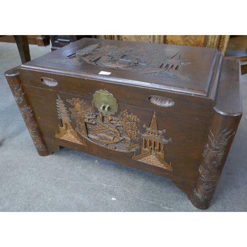 107 - A Chinese carved camphorwood blanket box