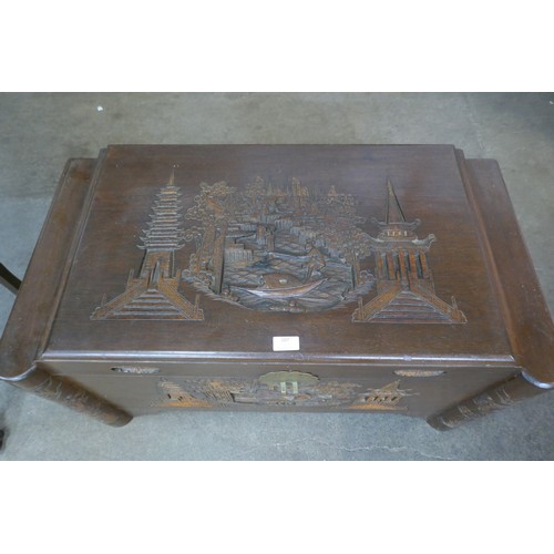 107 - A Chinese carved camphorwood blanket box