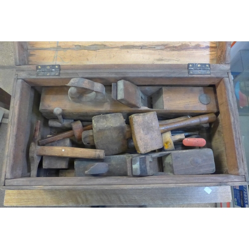2036 - An engineer's wooden tool box containing an assortment of tools including wooden block planes, malle... 