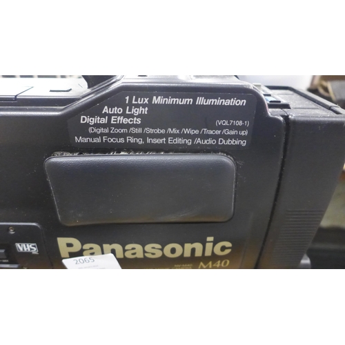 2065 - A Panasonic M40 video camera with tapes, tripod stand and roller