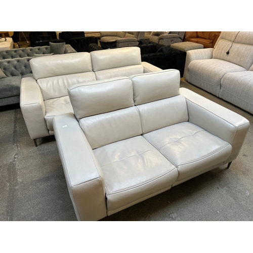 1576 - A three seater white leather and two seater white leather electric reclining sofas