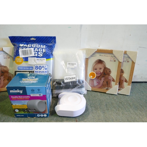 3105 - Fabric storage box containing assorted household items inc Vacuum Bags, Picture frames, Etc. * This ... 