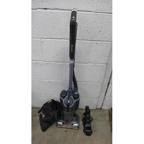 2174 - A Shark upright cordless vac - model K2160UK26, 28.8v with charger and accessories and a hand held S... 