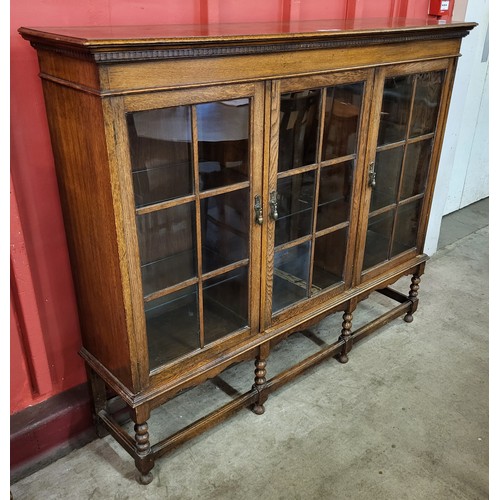 119 - An early 20th Century oak three door bookcase