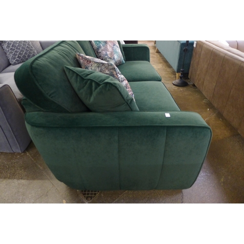 1387 - A deep green velvet three seater sofa