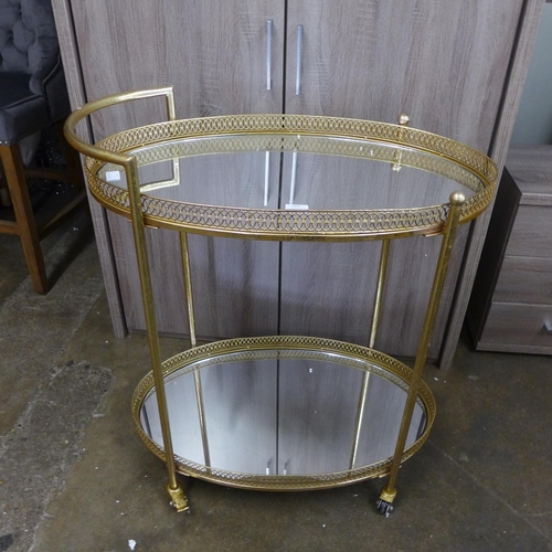 1392 - A gold mirrored drinks trolley
