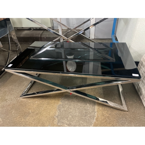 1439 - A black glass and chrome 'X' base coffee table and lamp table* this lot is subject to VAT