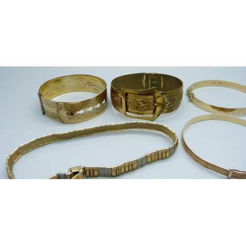 1006 - Three rolled gold bangles, one other bangle and a bracelet