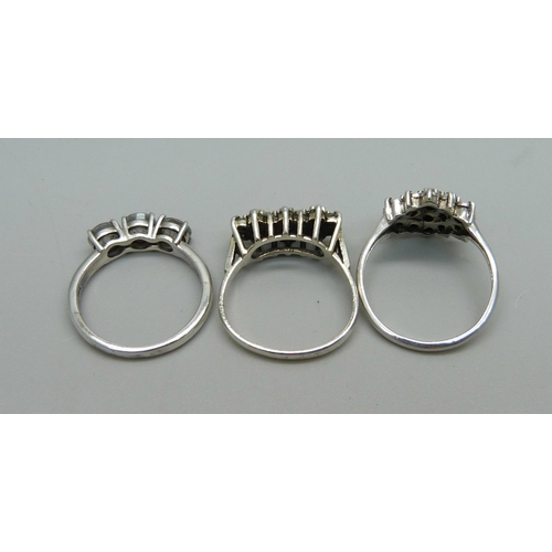 1007 - Three silver stone set rings, 2x N and P, cluster set with small diamonds