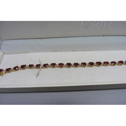 1010 - A silver gilt stone set bracelet and a Swarovski line bracelet