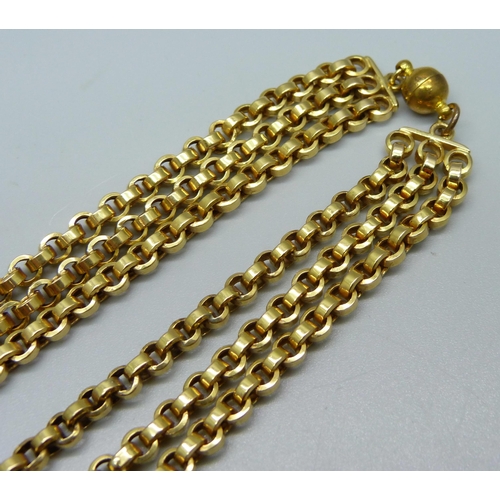 1018 - A triple strand gold tone necklace, magnetic fastener