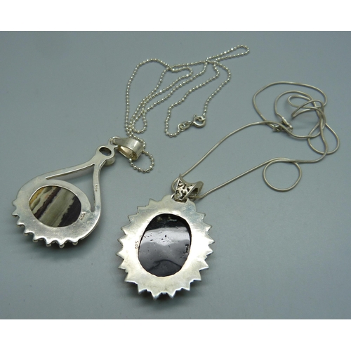 1025 - Two silver pendants and chains