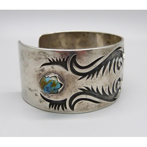 1030 - A silver and stone set bangle, marked sterling, Navajo style