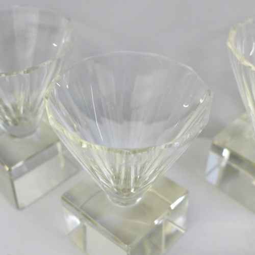 630 - Four heavy crystal glass liqueur glasses, signatures worn and each base chipped