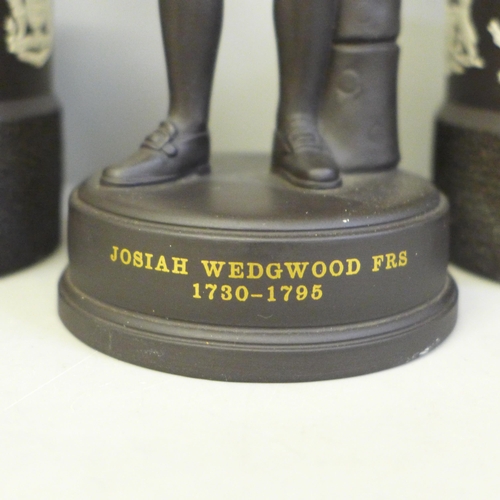 636 - A Wedgwood Josiah Wedgwood figure and a pair of Wedgwood black basalt tobacco jars with match strike... 