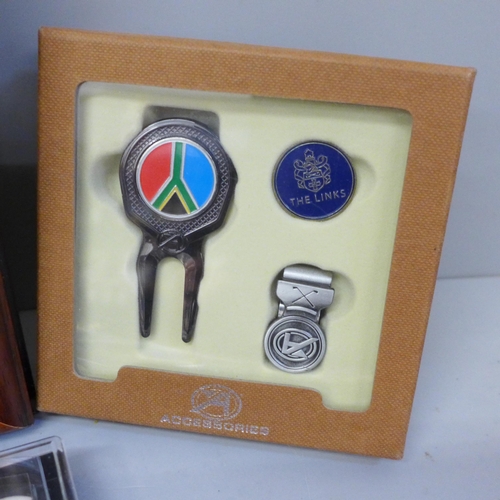 662 - A collection of golf related items including a framed display of ball markers and other assorted ite... 