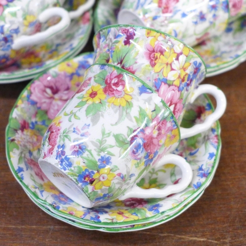 682 - A pair of Staffordshire spaniels and Brama chintz cups and saucers, one cup chipped