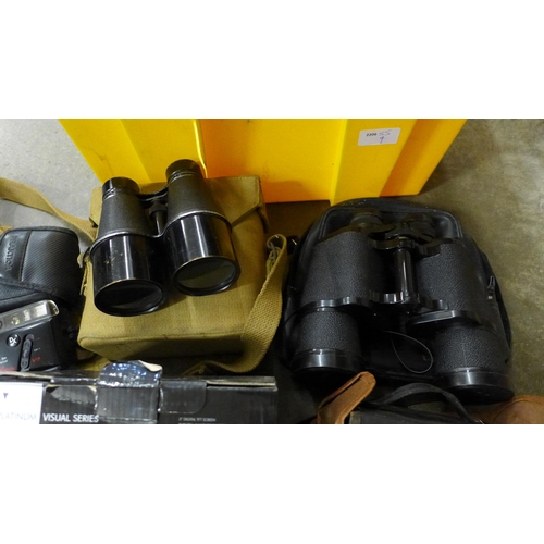 706 - A pair of binoculars in a military issue carrying case, one other pair of binoculars and a collectio... 