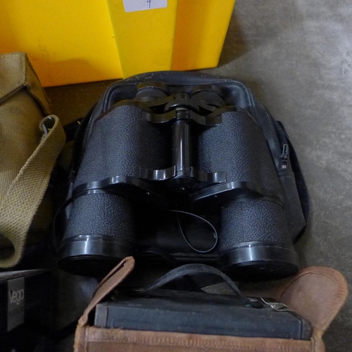 706 - A pair of binoculars in a military issue carrying case, one other pair of binoculars and a collectio... 