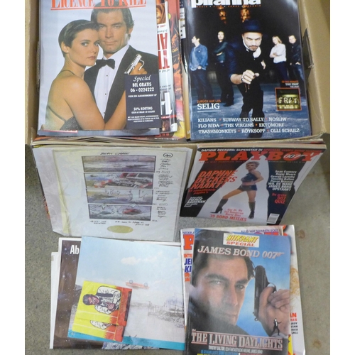 716 - A collection of James Bond magazines, poster, James Bond related Playboy issues, etc.