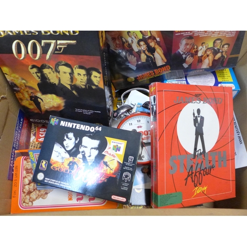 730 - A James Bond Collection including clock, flyers, games, cereal packets, VHS/CD sets, etc.