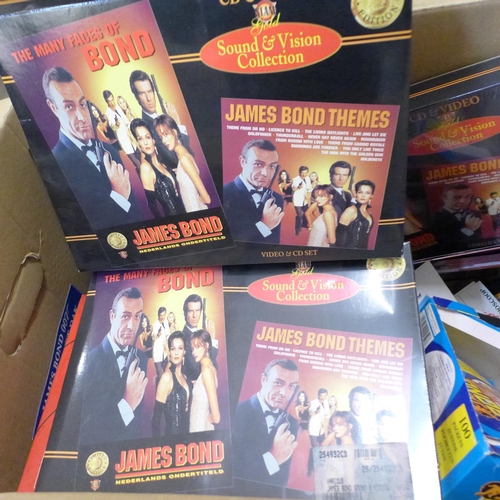 730 - A James Bond Collection including clock, flyers, games, cereal packets, VHS/CD sets, etc.