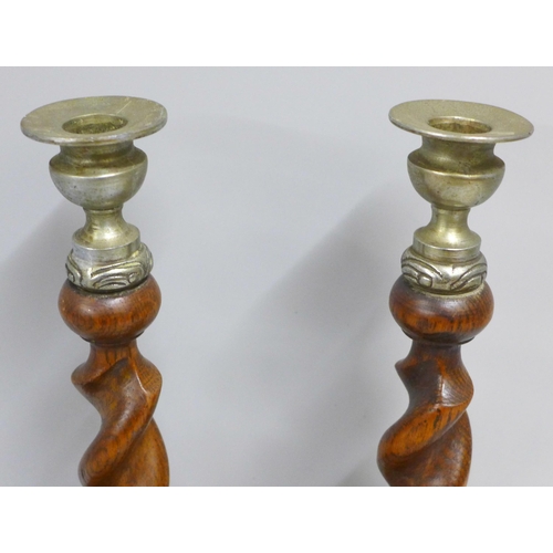 781 - A pair of oak barleytwist candlesticks