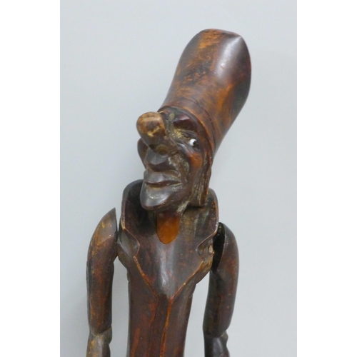 785 - A carved wooden figural pipe and stand, a/f, one eye missing, 41cm