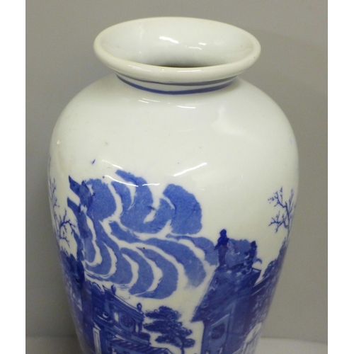 790 - A pair of blue and white vases and a pottery jug