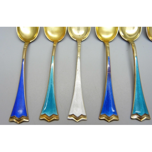 858 - A set of six silver gilt and enamel coffee spoons, stamped 925S, enamel a/f on one white and one roy... 