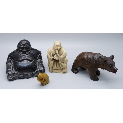 861 - A carved Black Forest bear, a Buddha figure, a resin netsuke and a small carved figure