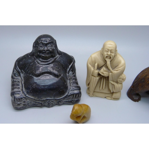 861 - A carved Black Forest bear, a Buddha figure, a resin netsuke and a small carved figure