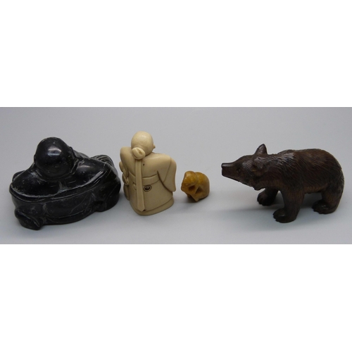 861 - A carved Black Forest bear, a Buddha figure, a resin netsuke and a small carved figure