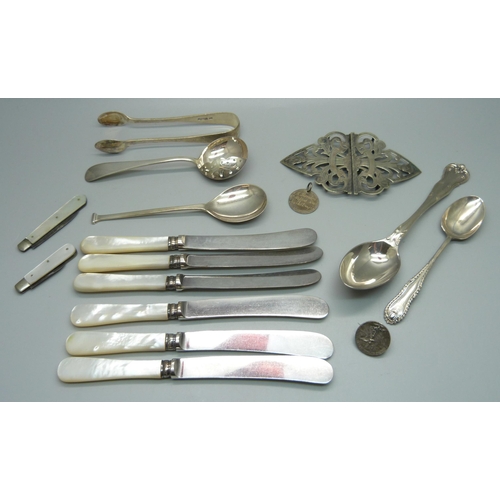 879 - Four silver spoons, a pair of silver sugar bows, two silver and mother of pearl fruit knives, a plat... 