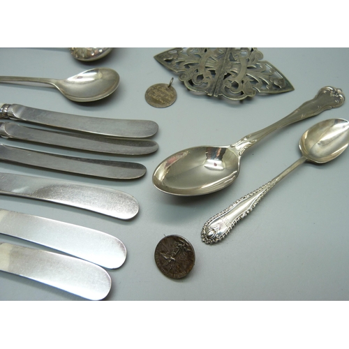 879 - Four silver spoons, a pair of silver sugar bows, two silver and mother of pearl fruit knives, a plat... 