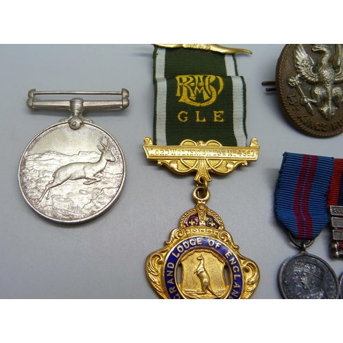 884 - A 14th King's Hussars badge, an Africa Service Medal to 211637 J. Wright, two miniature medals and a... 